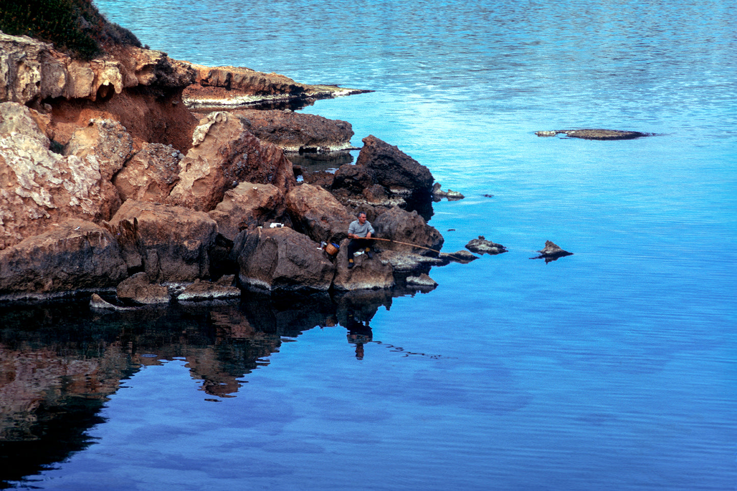 The fisherman in Vravrona and the reflections in the sea