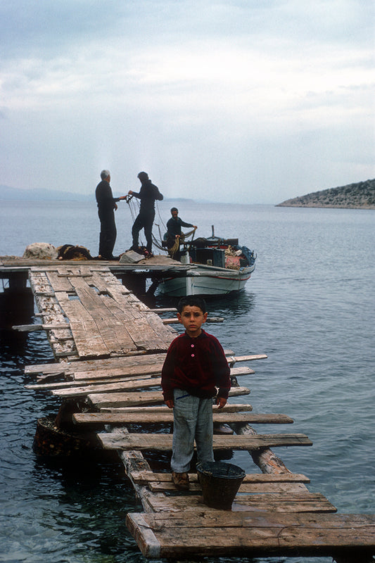 Paralia Thivon, the fishermen working and the young fisherman on the pier