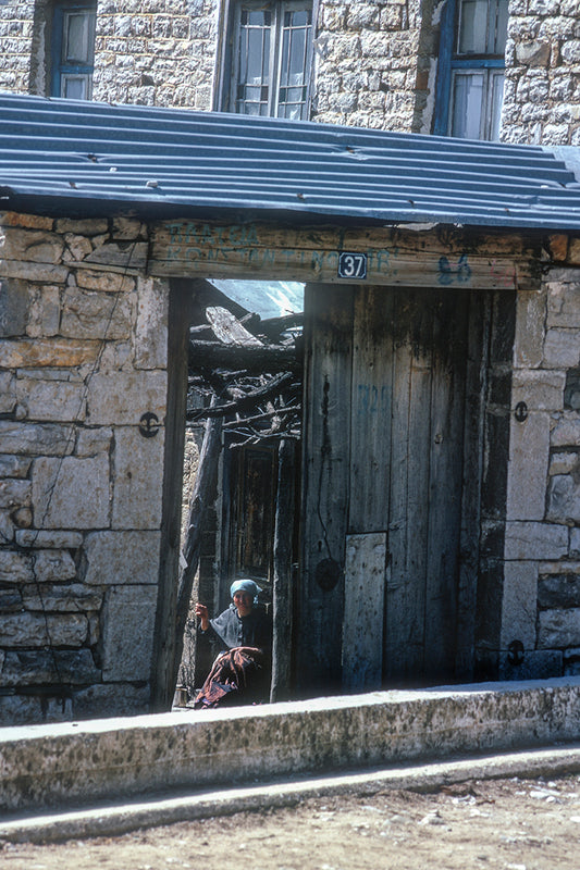 Epirus a woman in front of her doorstep