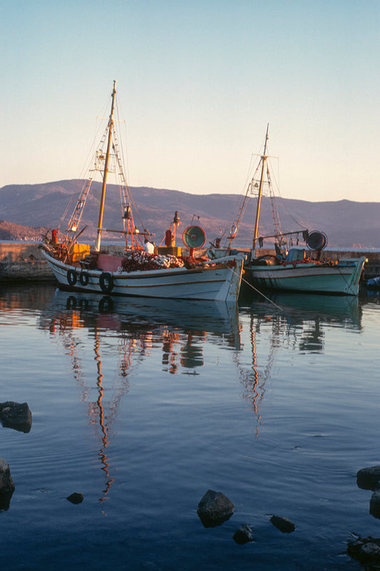 Reflection of fishing boats in Molyvos port in Mytilene