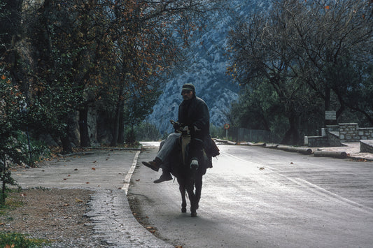 On his donkey going to towards Delphi