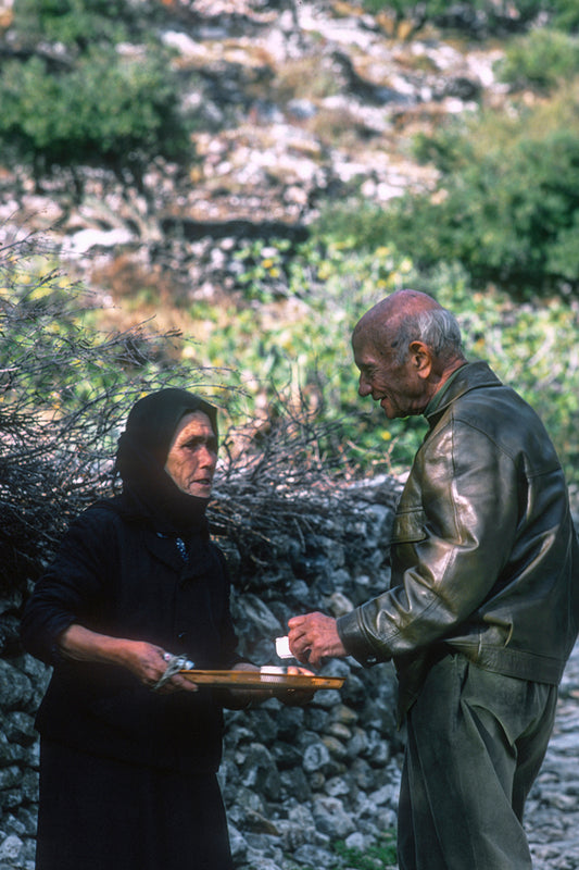 A woman of Mani chatting offering coffee